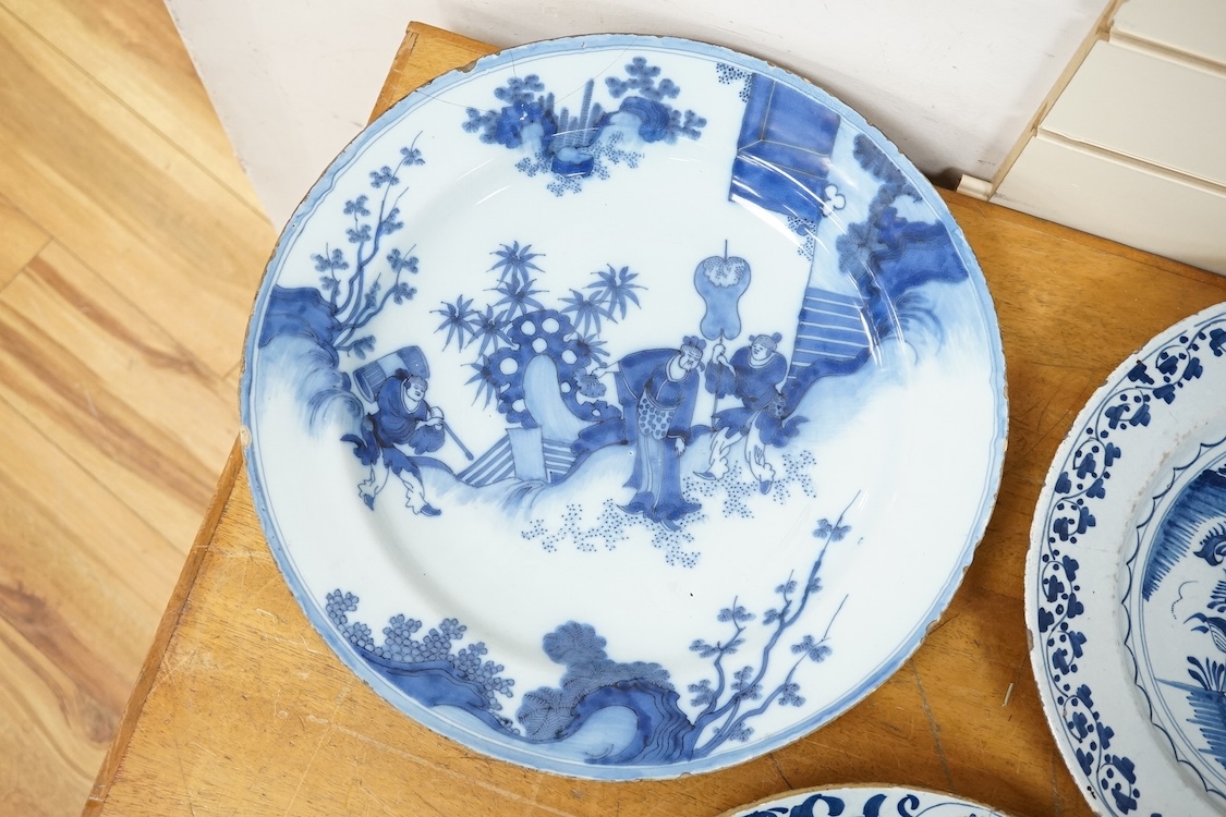 An 18th century English delftware ‘Chinese figures’ dish and two similar Delft dishes, largest 39cm diameter (3), largest 39cm